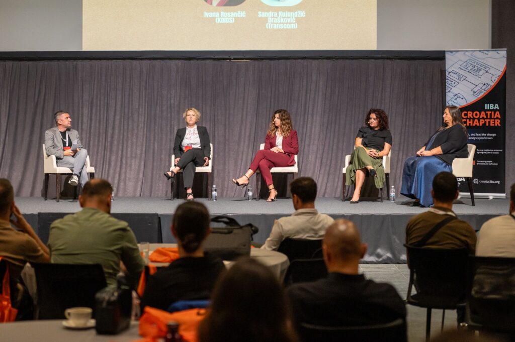 a group of business managers having a panel discussion at a conference